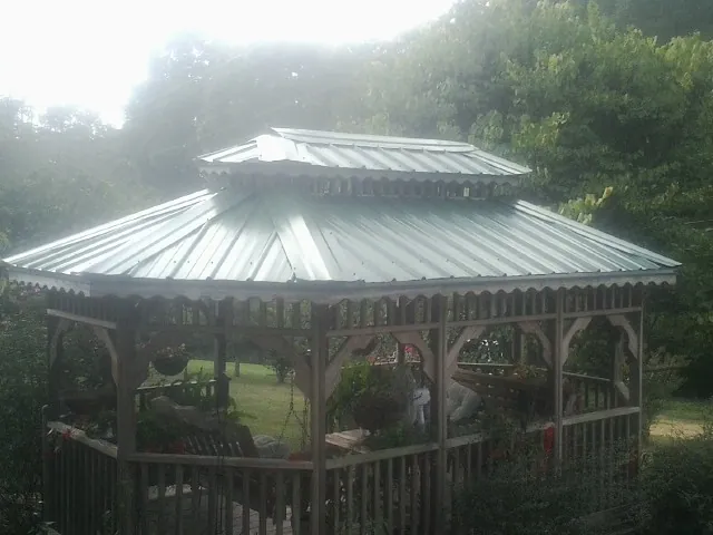 Two tier green metal roof on a garden gazebo in Gracemont